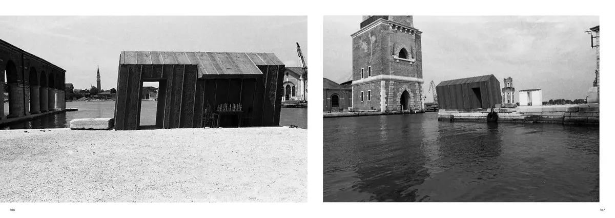 The finished dark timber house on the quay, facing the house beside the brick tower across the water