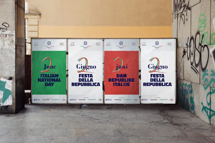 Four posters for 2 June on a city wall, in green, white and red