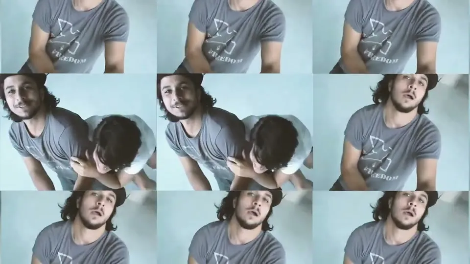 Nine frames in a grid: two performers against a pale blue wall, one leaning on the other's shoulder
